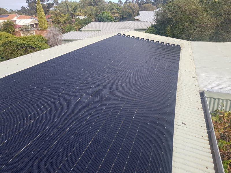 Coogee, Perth, WA. Swimming pool heating installation on Colorbond roof.