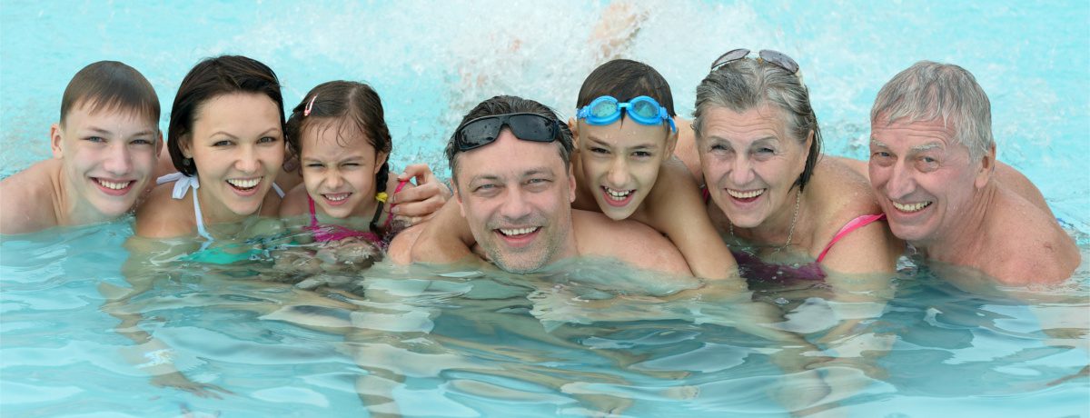 Happy family enjoying heated swimming pool